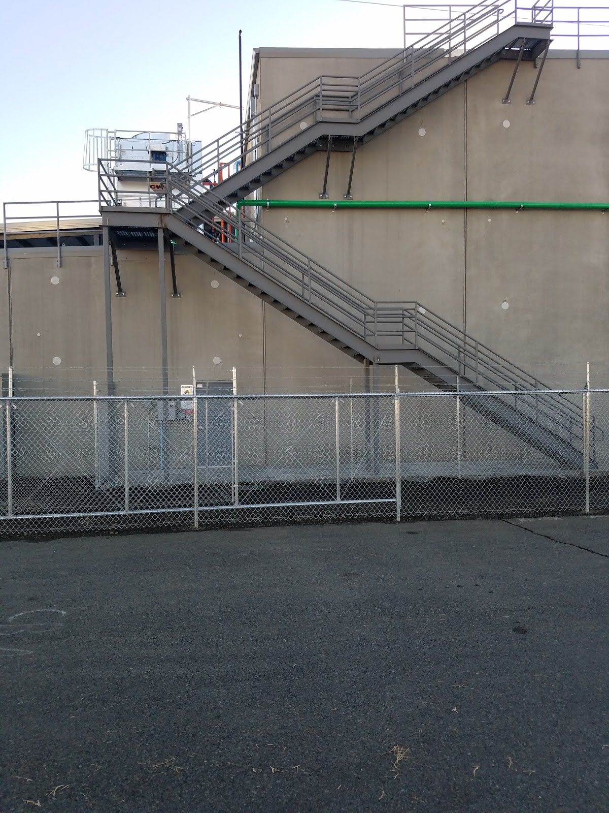 Galvanized chain link fence run beside a commercial structure in Yakima