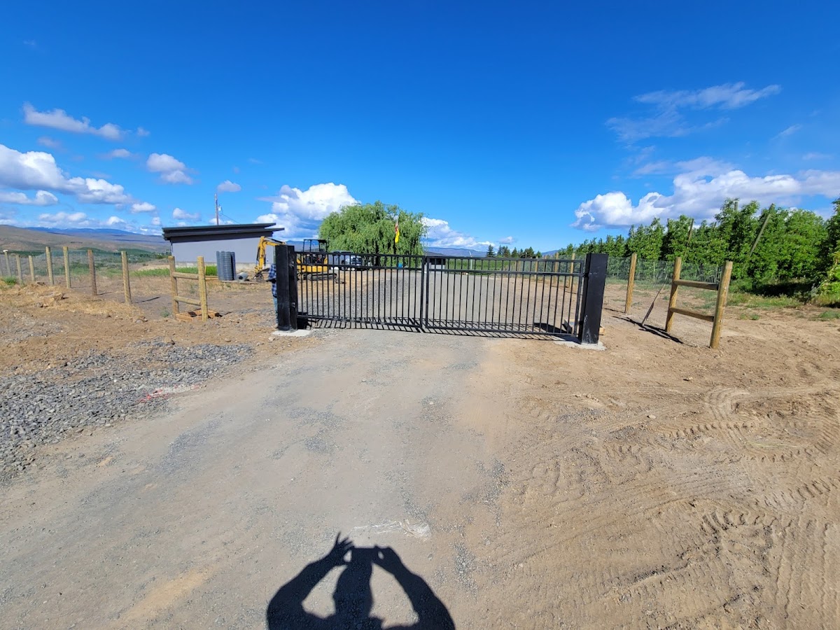 Custom black driveway gate built by L S Fencing on a Yakima Valley property